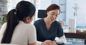 Healthcare professional explaining ultrasound results during a pregnancy consultation.