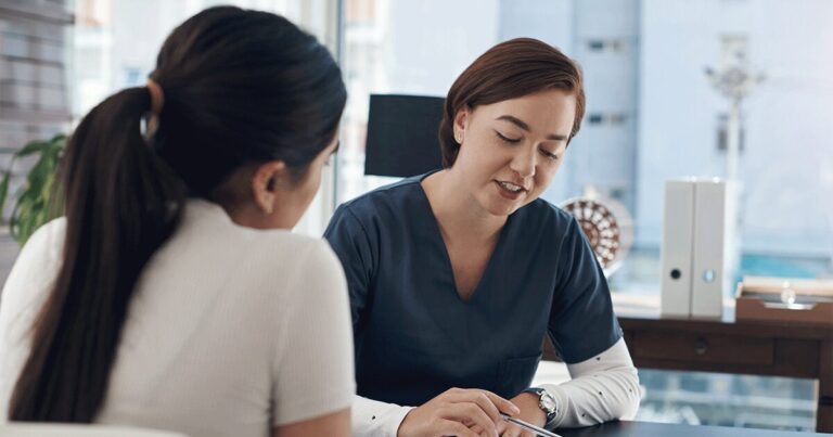 Healthcare professional explaining ultrasound results during a pregnancy consultation.